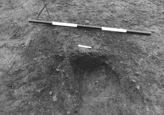 Excavation photograph : area 3 - f3023, half section, intrusive feature, from E.