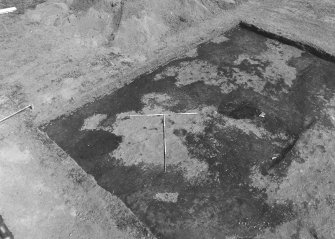 Excavation photograph : area 4 - sample square E, pre ex, NW corner, from SW.