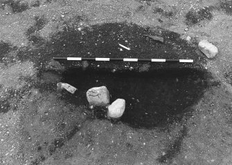 Excavation photograph : area 4 - f4087/4122 double feature revealed after fill A removed.