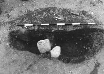 Excavation photograph : area 4 - f4122/4087, half section with packing, from E.