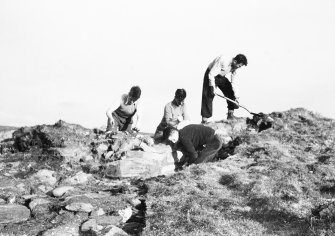 Working shot showing 4 individuals removing turf.