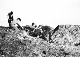 Working shot showing 4 individuals removing turf.