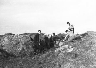 Photograph taken during excavation. Working shot showing 4 individuals.