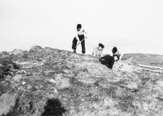 Photograph taken during excavation. Working shot showing 4 individuals.