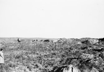 Photograph taken during excavation. Working shot showing 3 individuals.