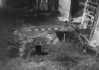 Excavation photograph ; area G - W facing mortar blocking to passageway.