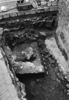 Excavation photograph : area L - dressed masonry wall footing with later rubble rebuild 803.