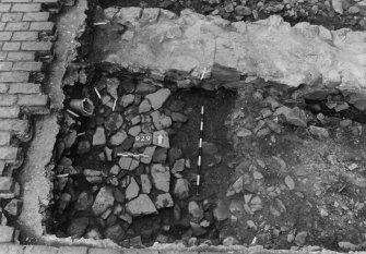 Excavation photograph : area N - detail of small paving 929 in SW corner of area.