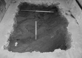 Excavation photograph : area P - trial hole in NE corner showing bedrock directly below concrete floor.