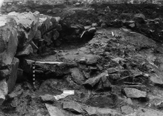 Excavation photograph : area N - lower dark layer with rubble 971 with bricks 955 above.