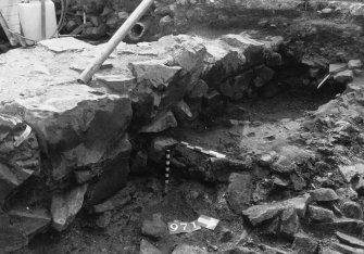 Excavation photograph : area N - lower dark layer with rubble 971 with bricks 955 above.