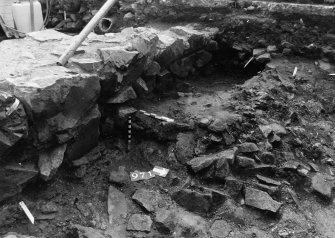 Excavation photograph : area N - lower dark layer with rubble 971 with bricks 955 above.