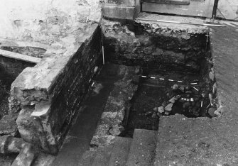 Excavation photograph : area K - further excavation of stables yard cobbles 743 with pipe trenches 725 and 744.