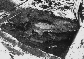 Excavation photograph : area M - polygonal cut under grave 1144 filled with mortar, cutting top of backfilled ditch.