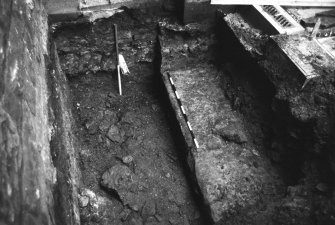 Excavation photograph : area L - wall found in SE corner of guardhouse forecourt, abutted by 1880 guardhouse.