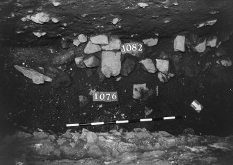 Excavation photograph: area X - patch of stones with 1076.