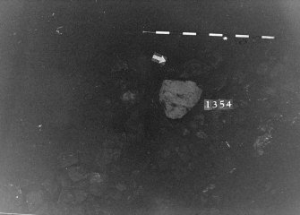 Excavation photograph: area X - f1354 further extent of stones.