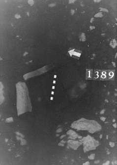 Excavation photograph: area X - flagstones below top layer in hearth arrangement.