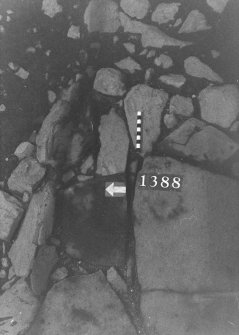 Excavation photograph: area X - flagstones showing position od triangular cut mark.