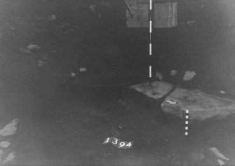 Excavation photograph: area X - cobbles 1394 under flagstones.