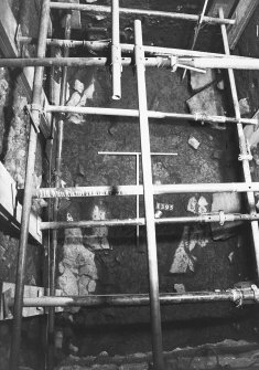 Excavation photograph: area X - extensive layer of disturbed yellow boulder clay with post holes 1396 and 1398 emptied.