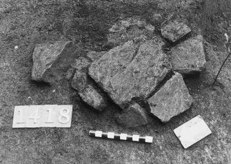 Excavation photograph: area H/X - stone setting - post hole feature.