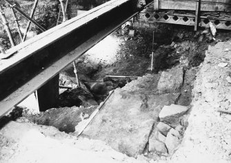 Excavation photograph: area H/X - section of wall below fireplace showing basement.