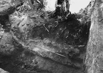 Excavation photograph: area H/X - working shots of wall 1066, N-S wall, and N wall of cart shed, slope of bedrock.