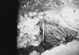 Excavation photograph: area H/X - detail of corner of 1066 and cross wall showing plaster.