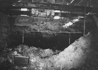 Excavation photograph: area H/X - E-W section showing midden from bedrock to cartshed floor, from NW.