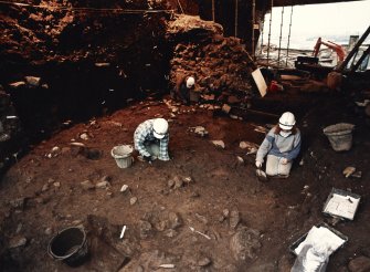 Excavation photograph : area X - excavation after removal of flagstones and cobbles.