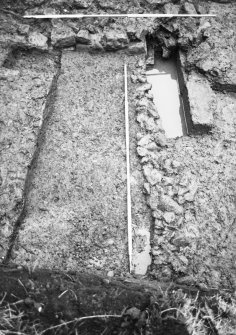 Dunfermline, Priory Lane, former Lauder Technical College, excavations.
Excavation photograph : trench 4 - west side of trench during excavation showing walls F141, 144 and rubble drain F145.