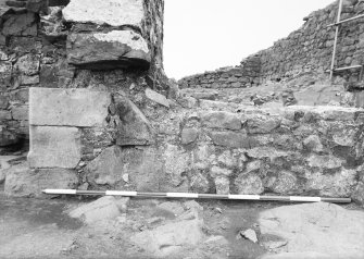 Excavation photograph - fireplace 2 - W side from N; blocked window 25 on right