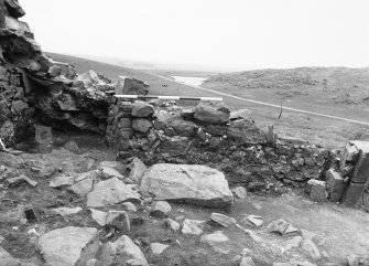 Excavation photograph - S face of N barmkin wall in Room III showing recess 35