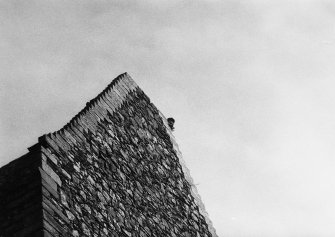 Excavation photograph - C J Tabraham at top of W gable of tower-house