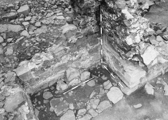 Excavation photograph - fireplace 2 - showing salt-box, fire back and hearth stones