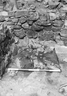 Excavation photograph - fireplace 21 partially excavated in Room II