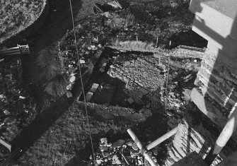 Excavation photograph : trench A - walls, floor of barmkin and small area of flagstones.