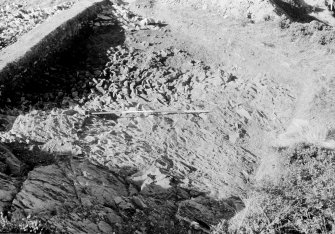 Excavation photograph : area II - rock cut base, looking west.