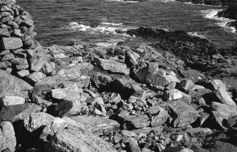 Dun Mor, Vaul, Tiree, broch.
Photograph showing the entrance passage filled with rubble and the filled guard cell, prior to excavation.