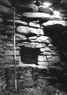 Mural cell by daylight showing possible Neolithic foundations and broch wall on top.