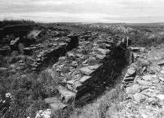 Outer wallface and concentric outer wall. Outbuildings to right.