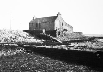 View from SW, also showing two walls of naust (open boathouse) and curing house to rear.