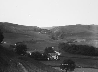Copy of historic photographic view of farmhouse in surrounding landscape.