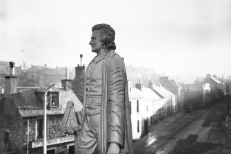 Copy of historic photograph showing detail of statue.