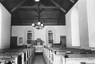 Copy of postcard showing interior view looking from pews towards altar.