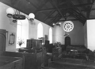 Copy of postcard showing interior view of pews, altar and rose window.