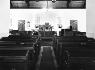 Copy of postcard showing interior view of pews and altar.