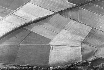 Oblique aerial view of Milton centred on the cropmarks of a cursus with cultivation remains adjacent.