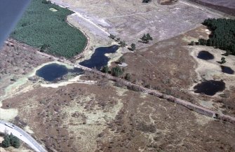 An oblique aerial view of Loch nan Carraigean, Duthil and Rotheirmurchus, Badenoch and Strathspey, looking ENE.